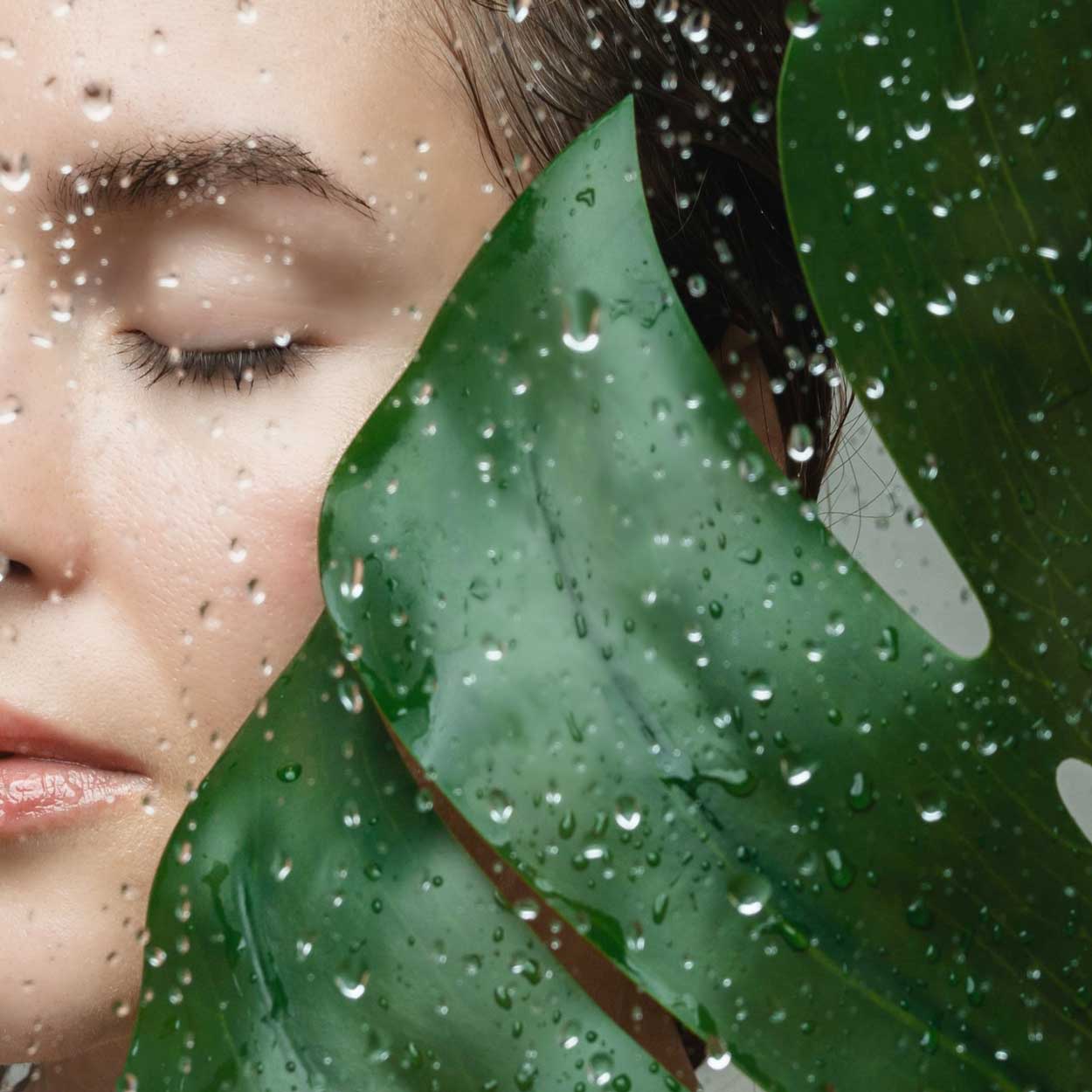 Woman's face with water and leaf - LightWater Skin Nutrition is fresh from source to skin helping to nourish skin with fresh actives